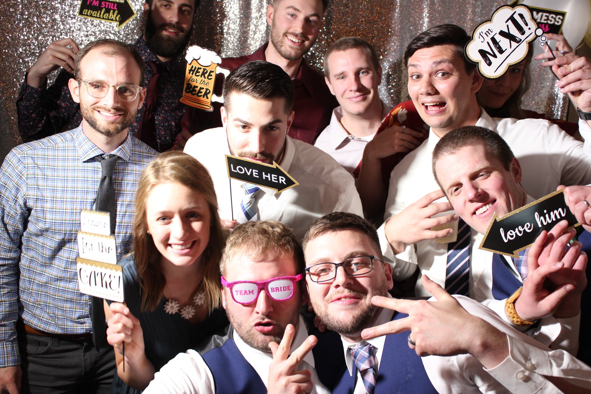An image of guys and a girl posing for a photobooth picture.